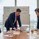 UK business team at cluttered boardroom table