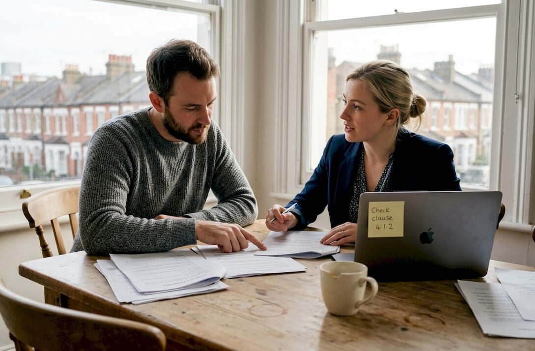 Couple reviewing property papers in London flat