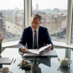 Solicitor and client discuss fees in city office