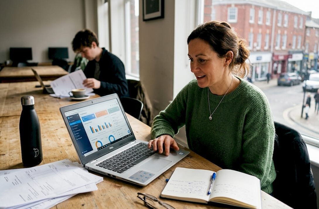 Small business owner using AI dashboard in workspace