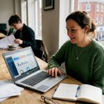 Small business owner using AI dashboard in workspace