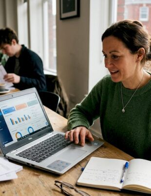 Small business owner using AI dashboard in workspace