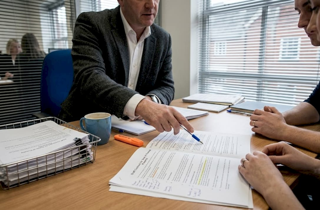 Conveyancer reviewing documents with clients