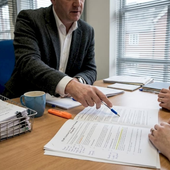 Conveyancer reviewing documents with clients